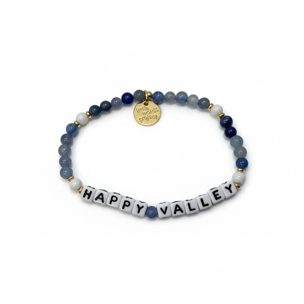 Bracelet with blue beads and 'Happy Valley' tile charm on a white background