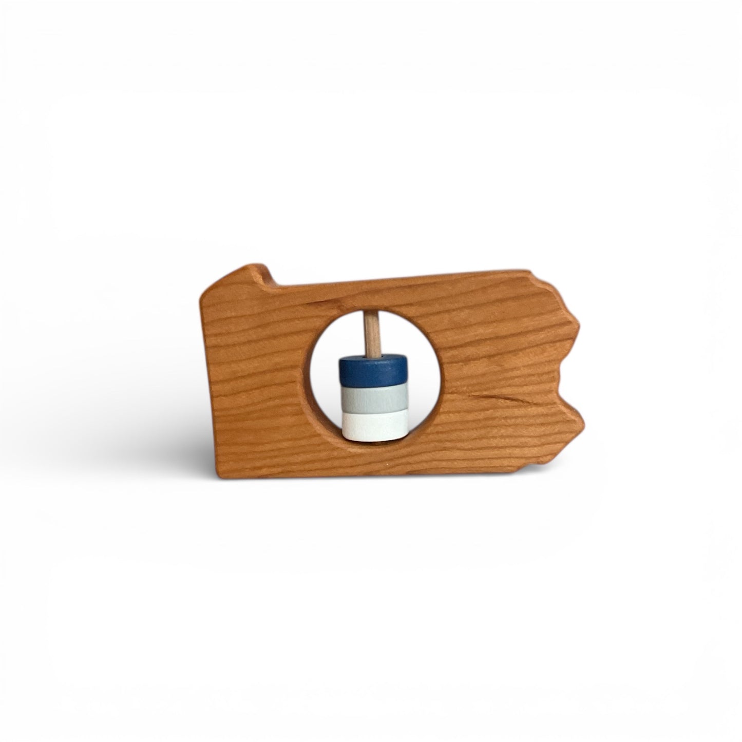 Wooden toy with a circular hole and a blue and white object inside on a white background