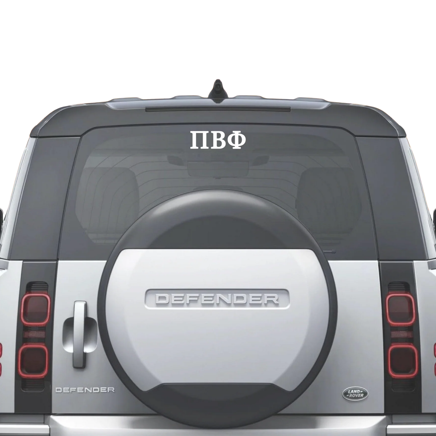 Back view of a Land Rover Defender with a spare tire cover and 'Defender' branding.
