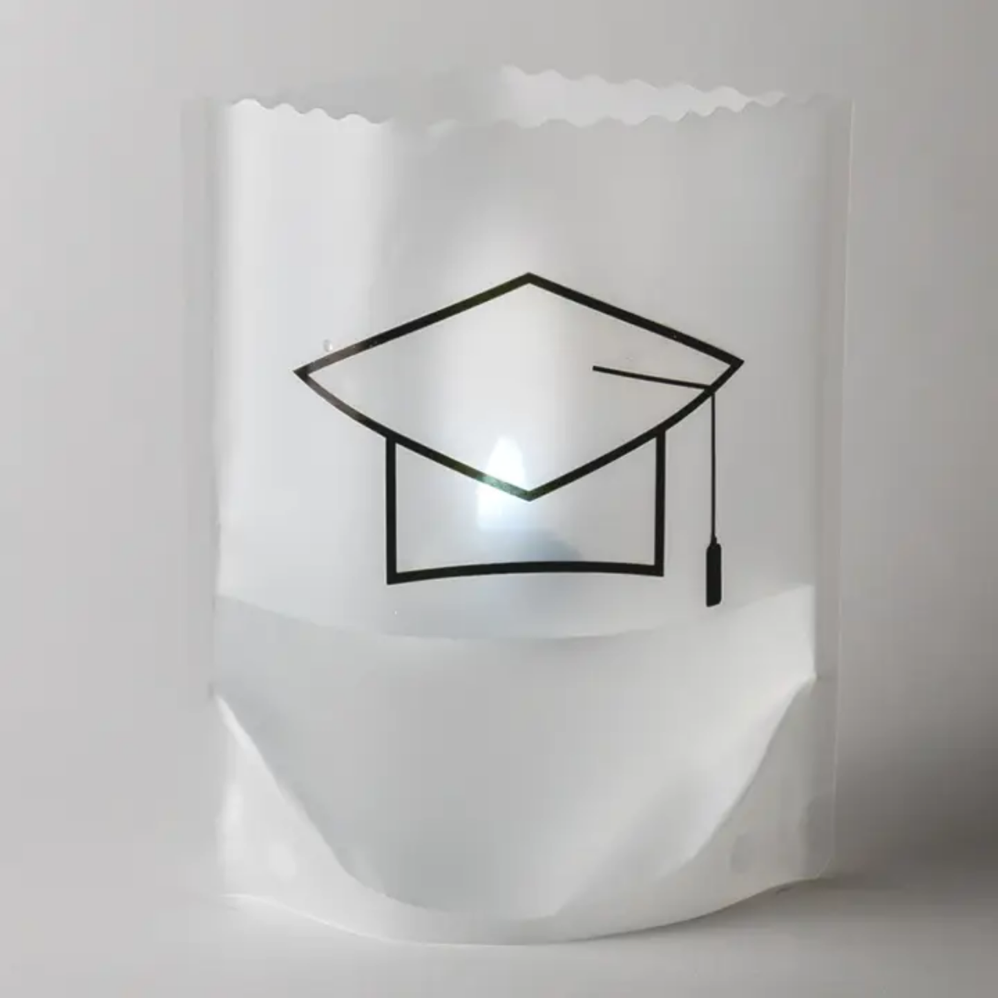 Reusable luminary with a black graduation cap design on a white background