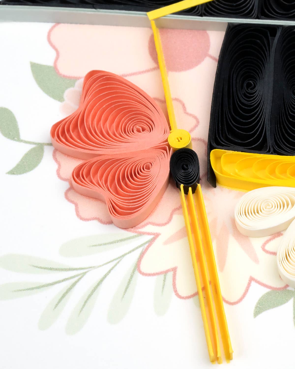 Decorative paper flowers and tools on a floral background