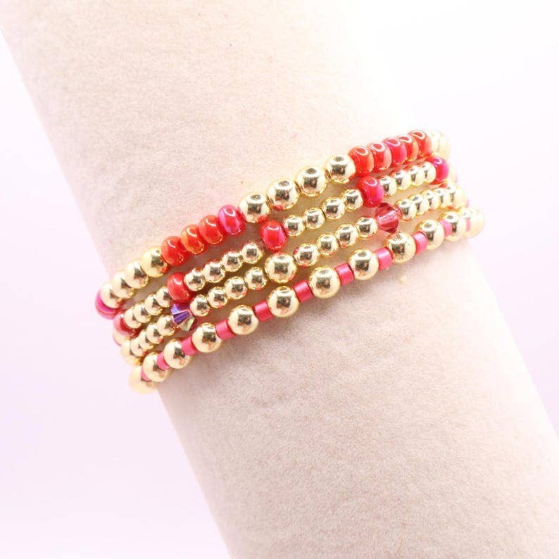 Town Pride State College hot pink and gold hematite stretch bracelet stack of five on a display stand