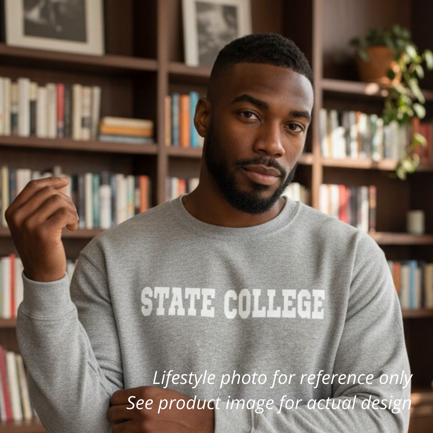 Man wearing a gray sweatshirt with 'STATE COLLEGE' text in front of a bookshelf.