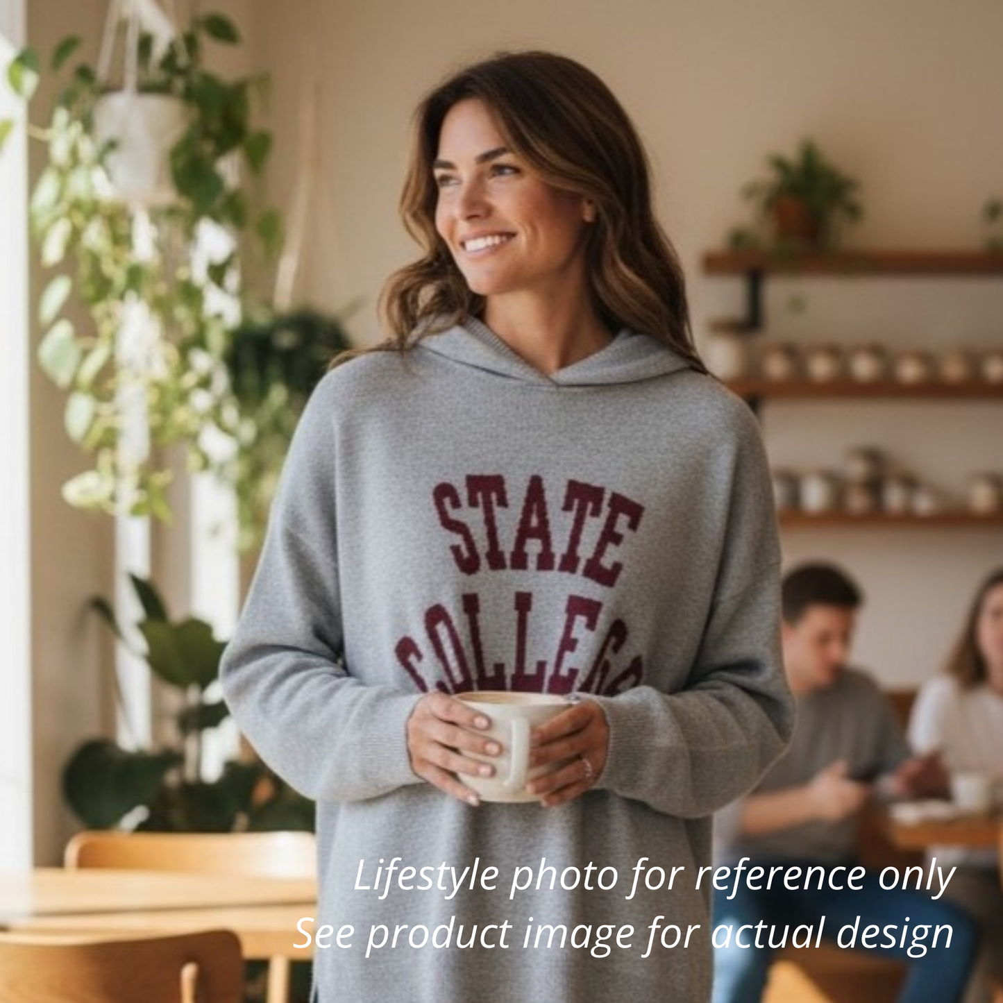 Woman wearing a gray hoodie with 'STATE COLLEGE' text, holding a mug in a casual setting.