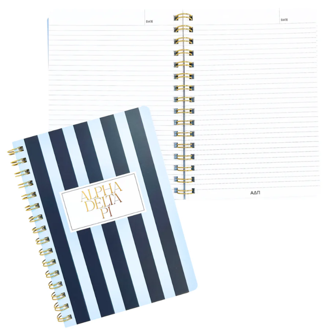 Notebook with blue and white striped cover and gold spiral binding on a white background
