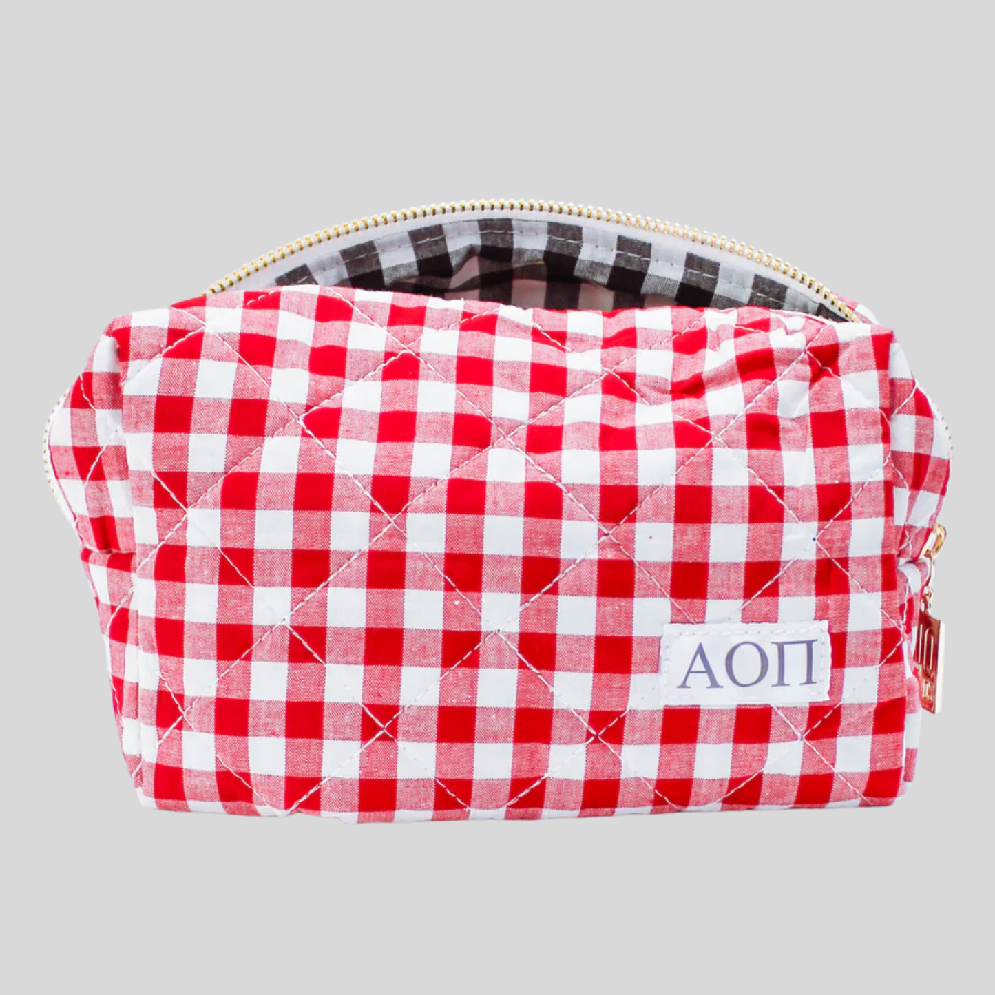 Red and white checkered pouch with 'ΑΟΠ' initials on a gray background