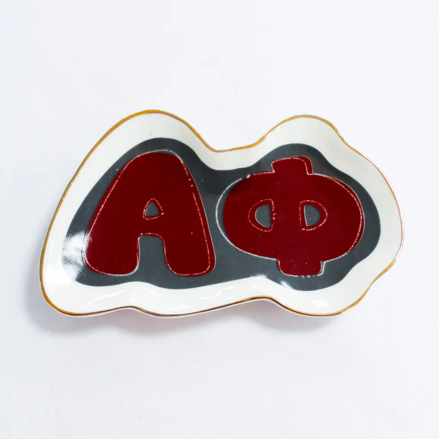 Decorative item with red letters 'A' and 'Phi' on a white background