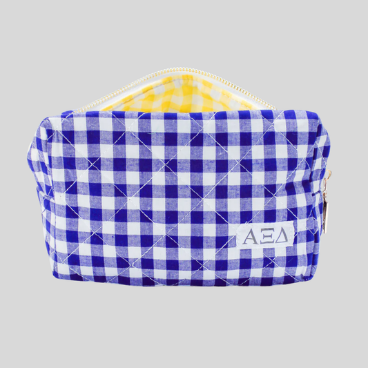 Blue and white checkered pouch with a yellow interior on a gray background