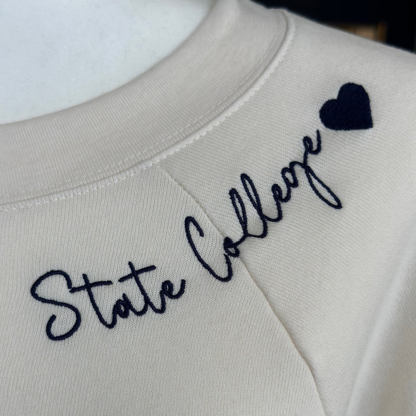 Textured fabric with embroidered text and heart design