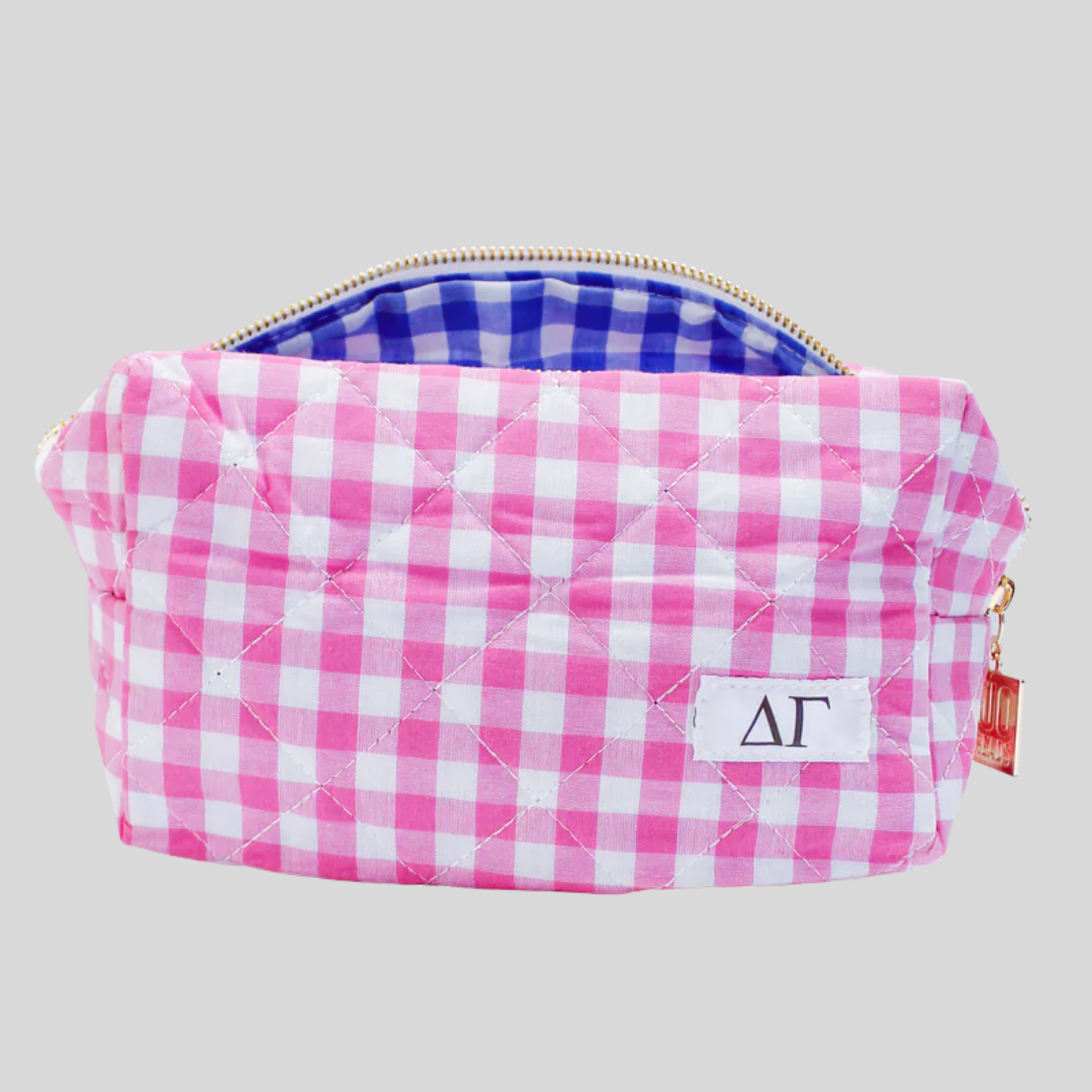 Pink and white checkered pouch with a gold zipper on a light gray background