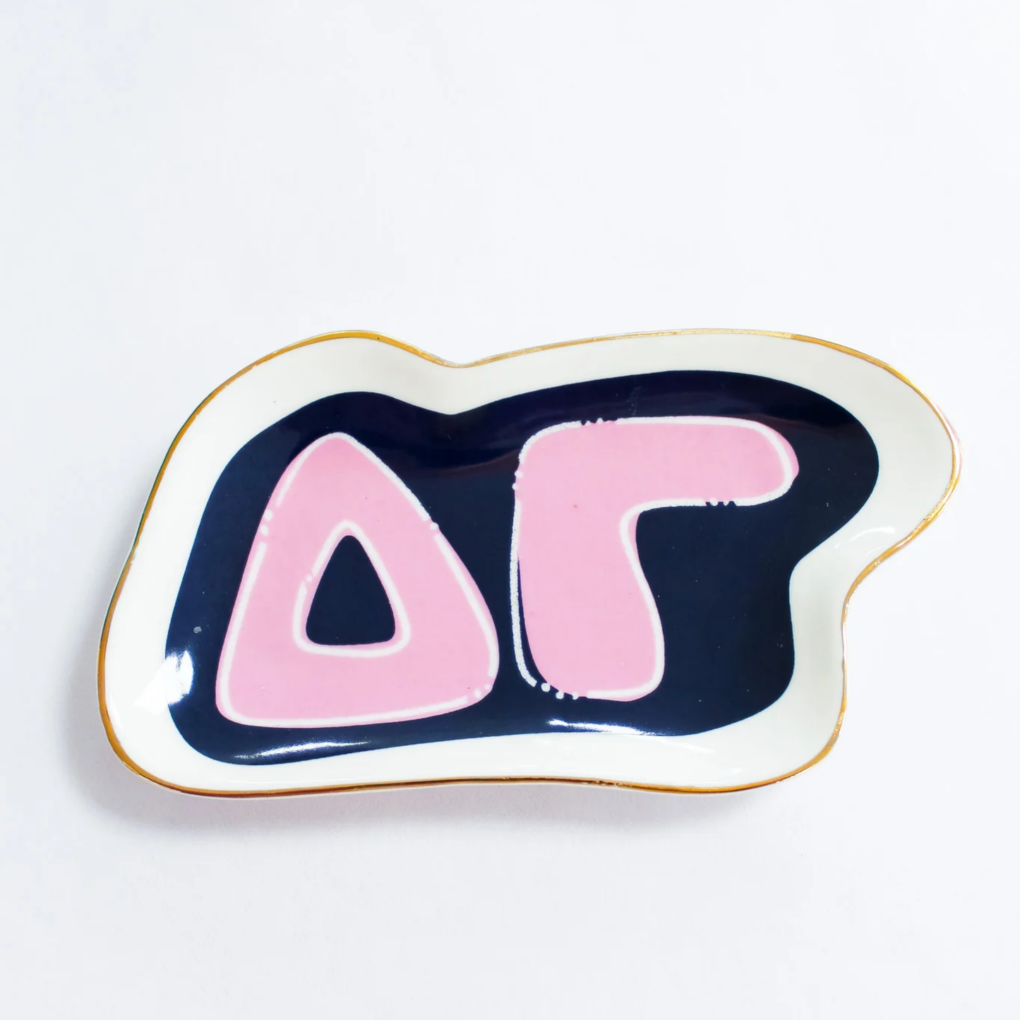 Decorative dish with pink and navy design on a white background