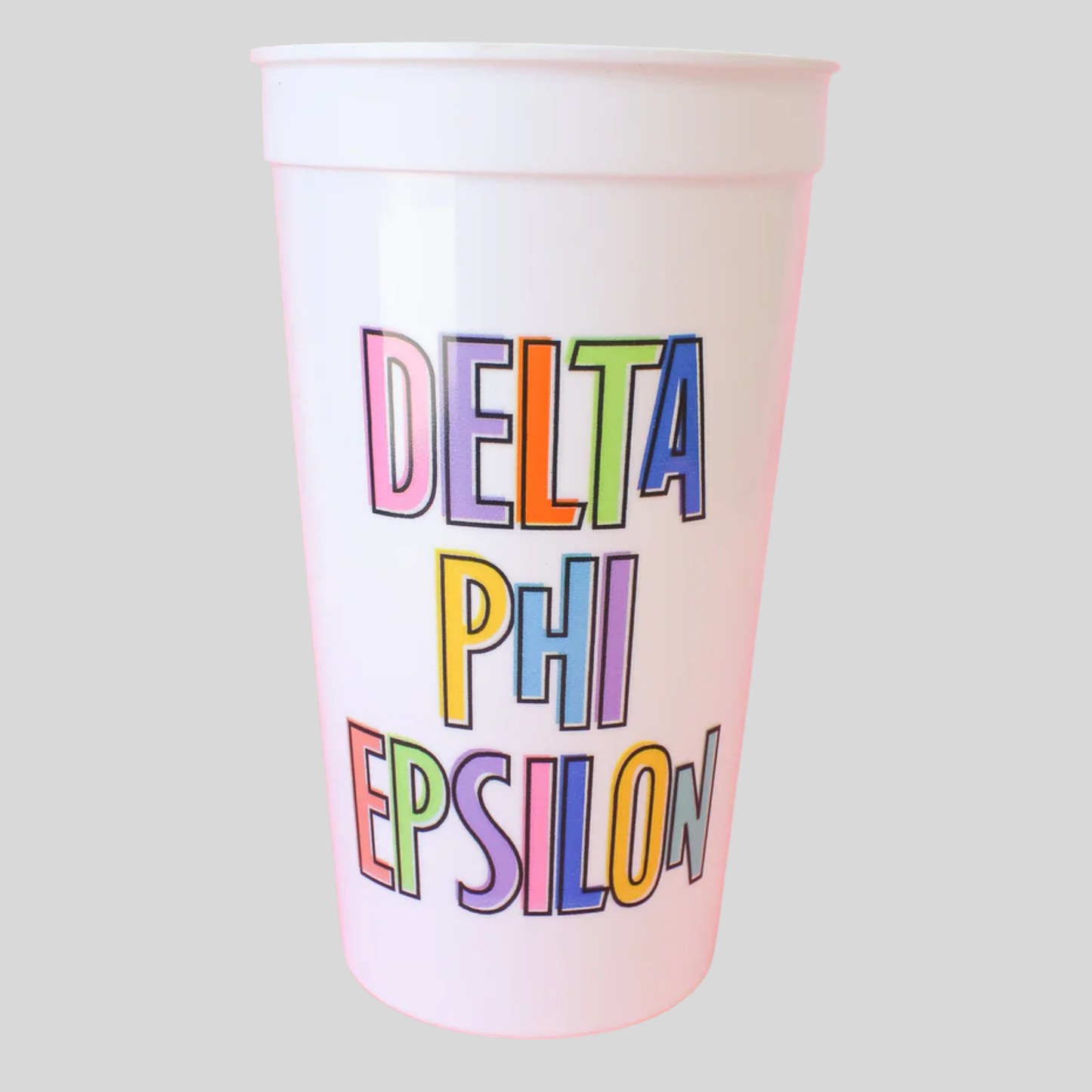 Whitw cup with 'Delta Phi Epsilon' in colorful letters on a light gray background