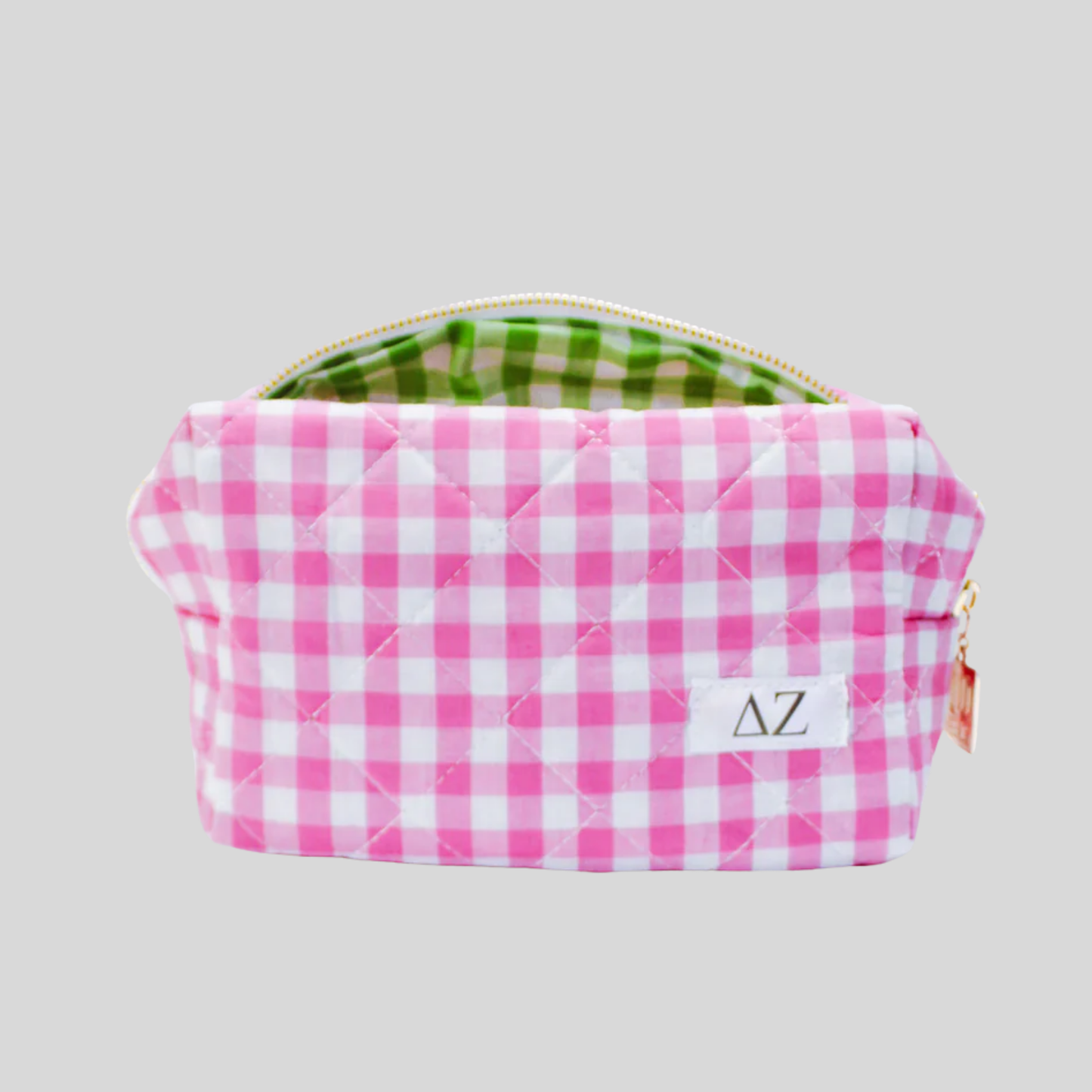 Pink and white checkered pouch with 'Delta Zeta' initials on a gray background