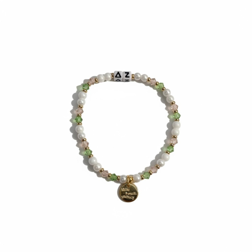 Beaded bracelet with a gold tag on a white background