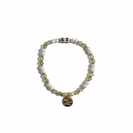 Beaded bracelet with a gold tag on a white background