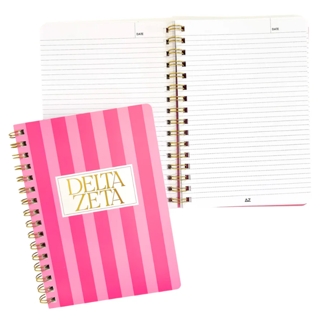 Pink spiral-bound notebook with gold stripes and 'Delta Zeta' logo on a white background