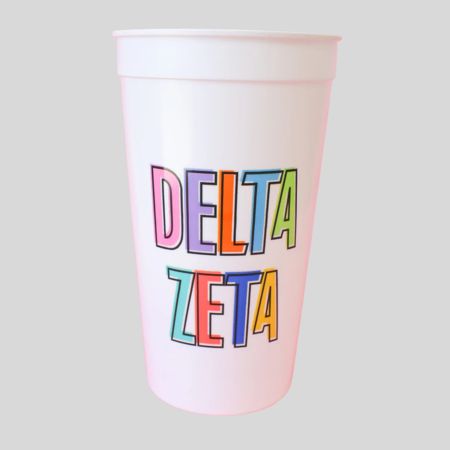 White cup with 'Delta Zeta' in colorful letters on a light gray background