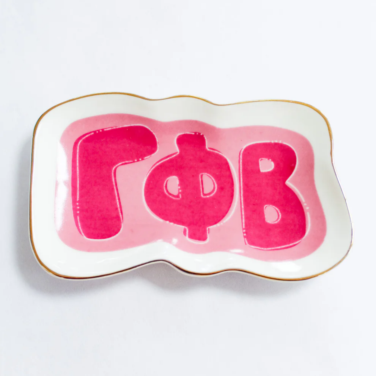 Decorative plate with pink letters 'Gamma Phi Beta' on a white background