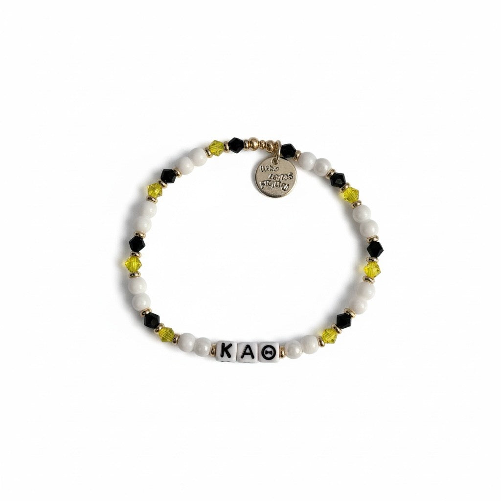 Bracelet with beads and letter tiles on a white background