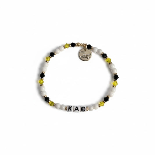 Bracelet with beads and letter tiles on a white background