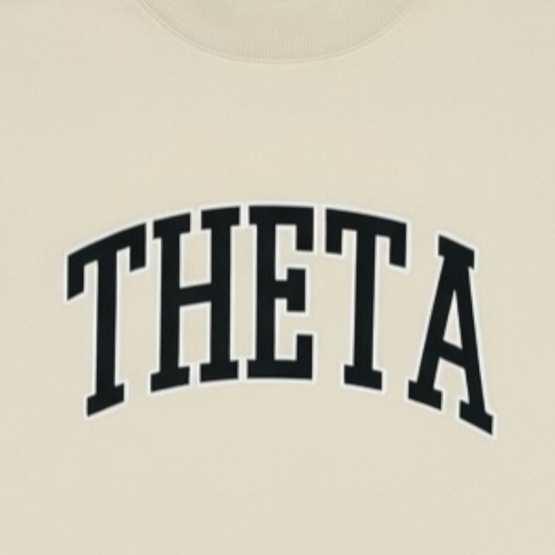 Beige shirt with 'THETA' printed in black letters