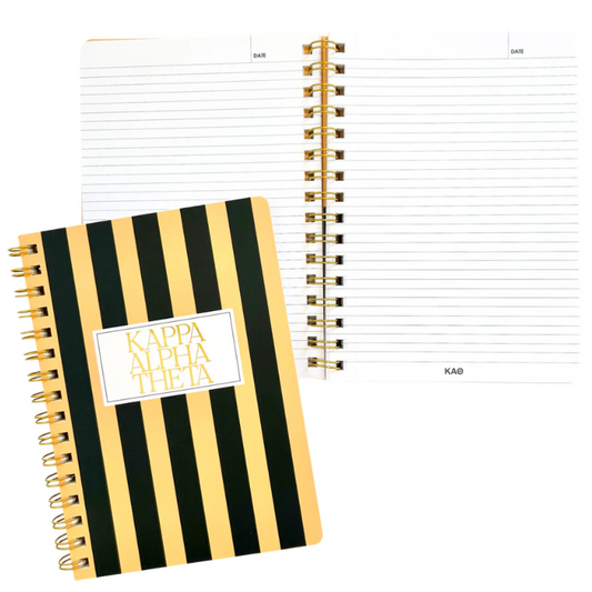 Notebook with black and yellow striped cover and visible brand name.