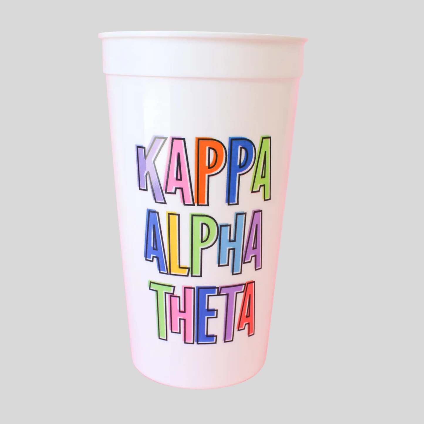 White cup with 'Kappa Alpha Theta' in colorful letters on a light gray background