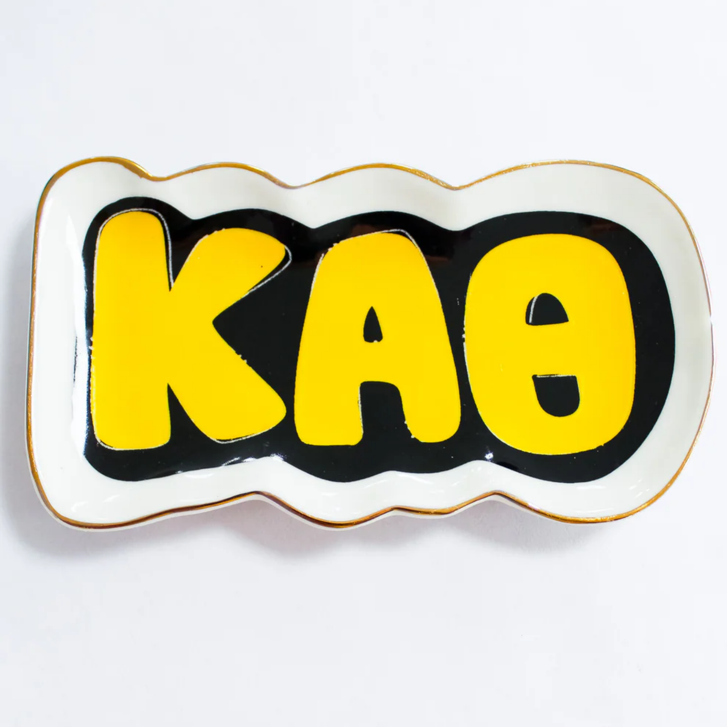 Decorative plate with yellow 'Kappa Alpha Theta' Greek letters on a white background