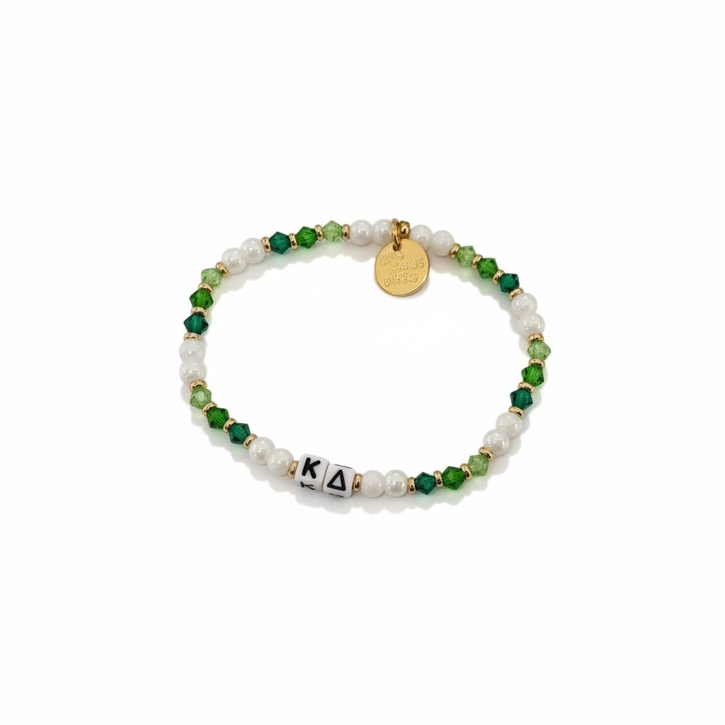 Beaded bracelet with green, white, and gold elements on a white background