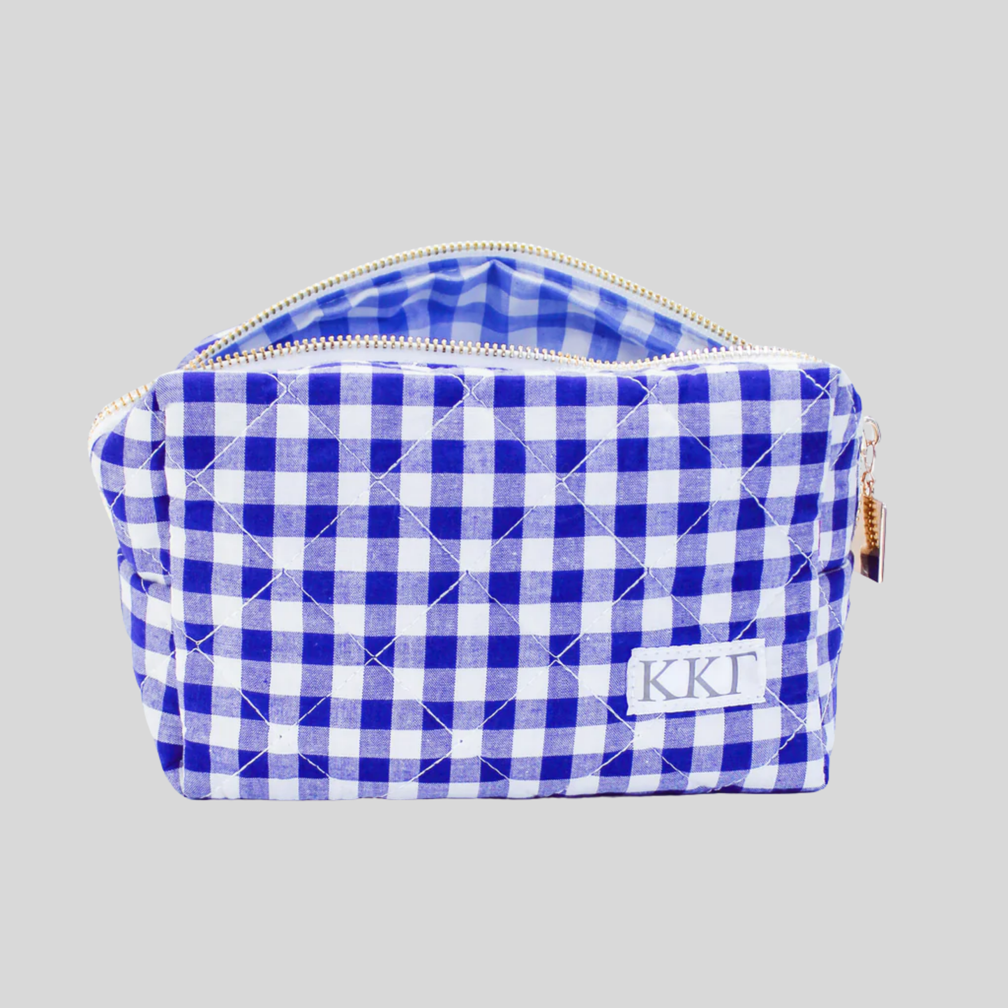 Blue and white checkered pouch with initials on a gray background