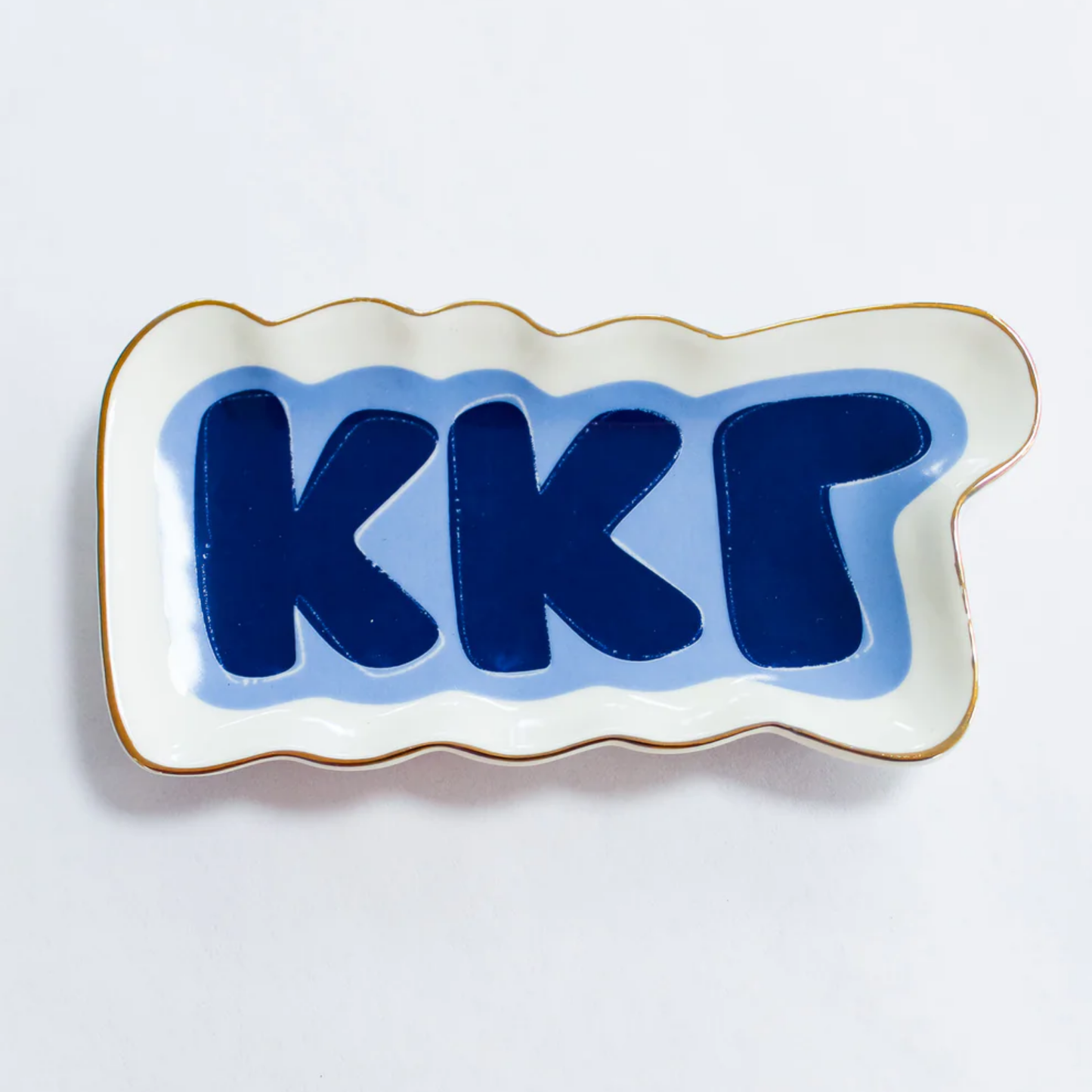 Decorative plate in blue letters on a white background