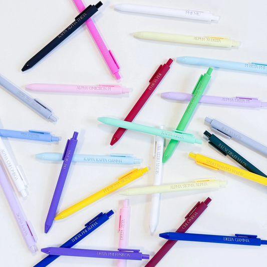 Assorted colorful pens scattered on a white background