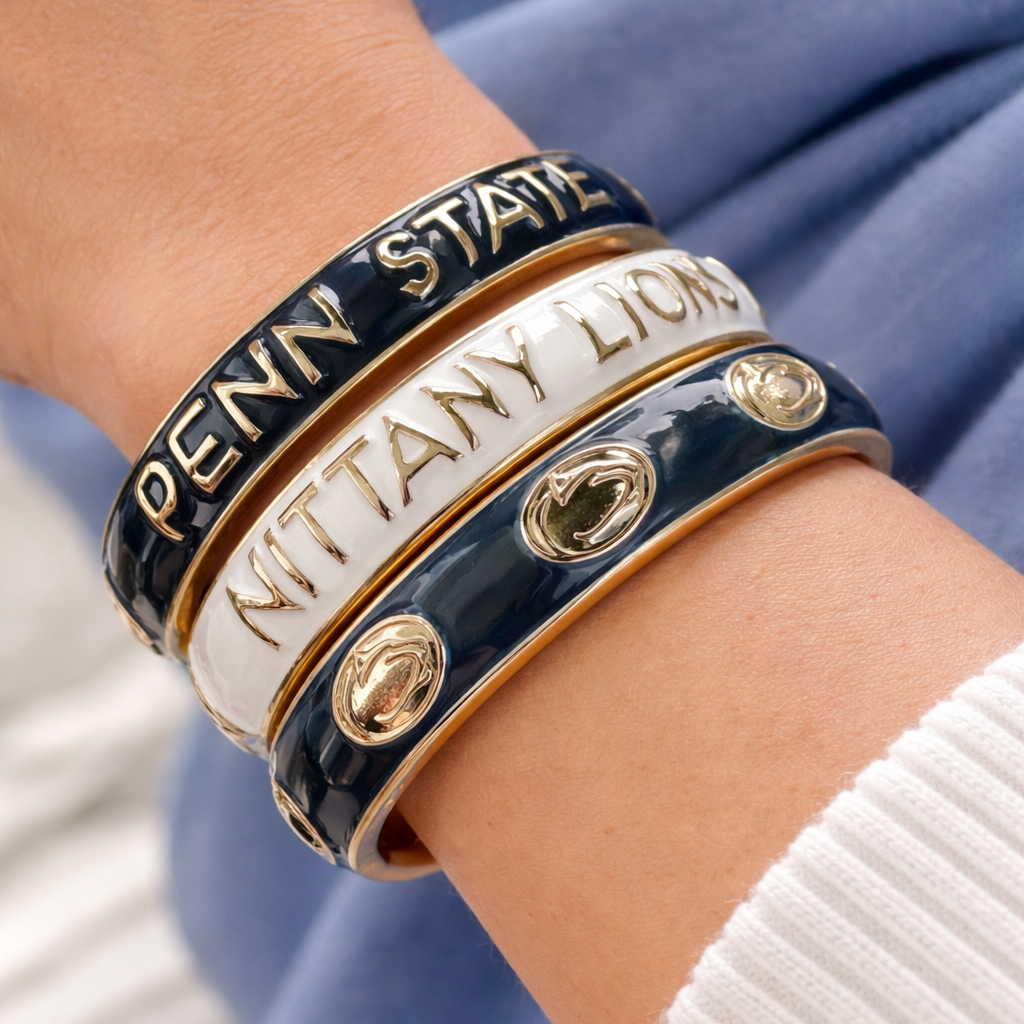 Bracelets with 'Penn State Nittany Lions' text on a wrist against a blurred background