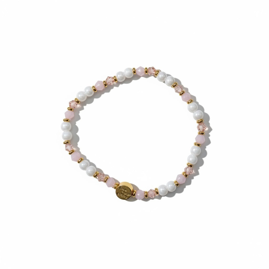 Beaded bracelet with pink and gold accents on a white background