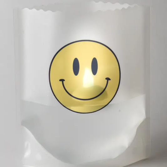 Reusable luminary with a yellow smiley face design on a white background