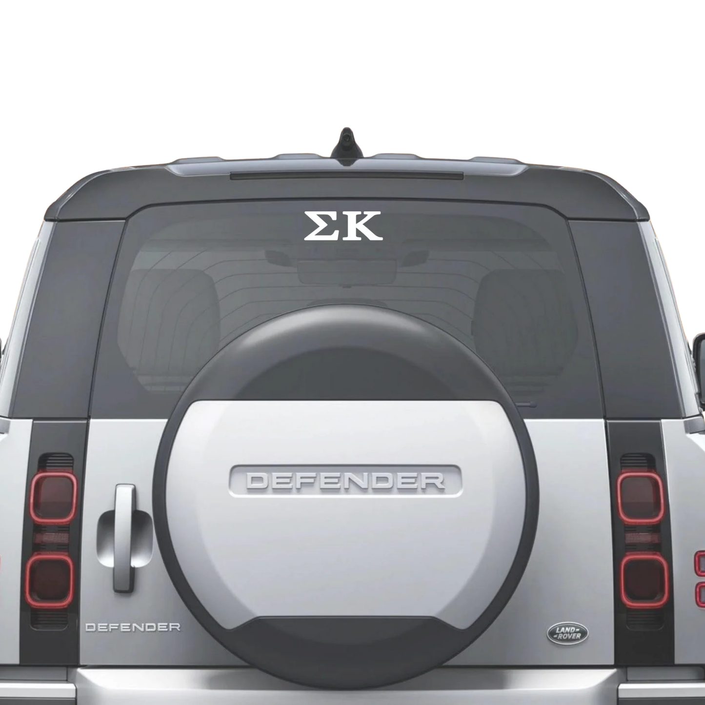 Back of an auto with a tire cover and 'Sigma Kappa' decal.