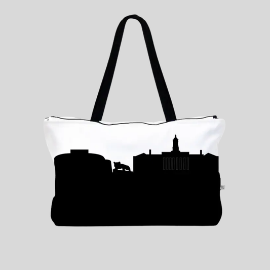 Tote bag with navy cityscape silhouette on a white background
