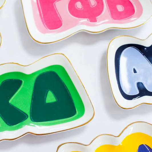 Colorful letters on trays on a white background