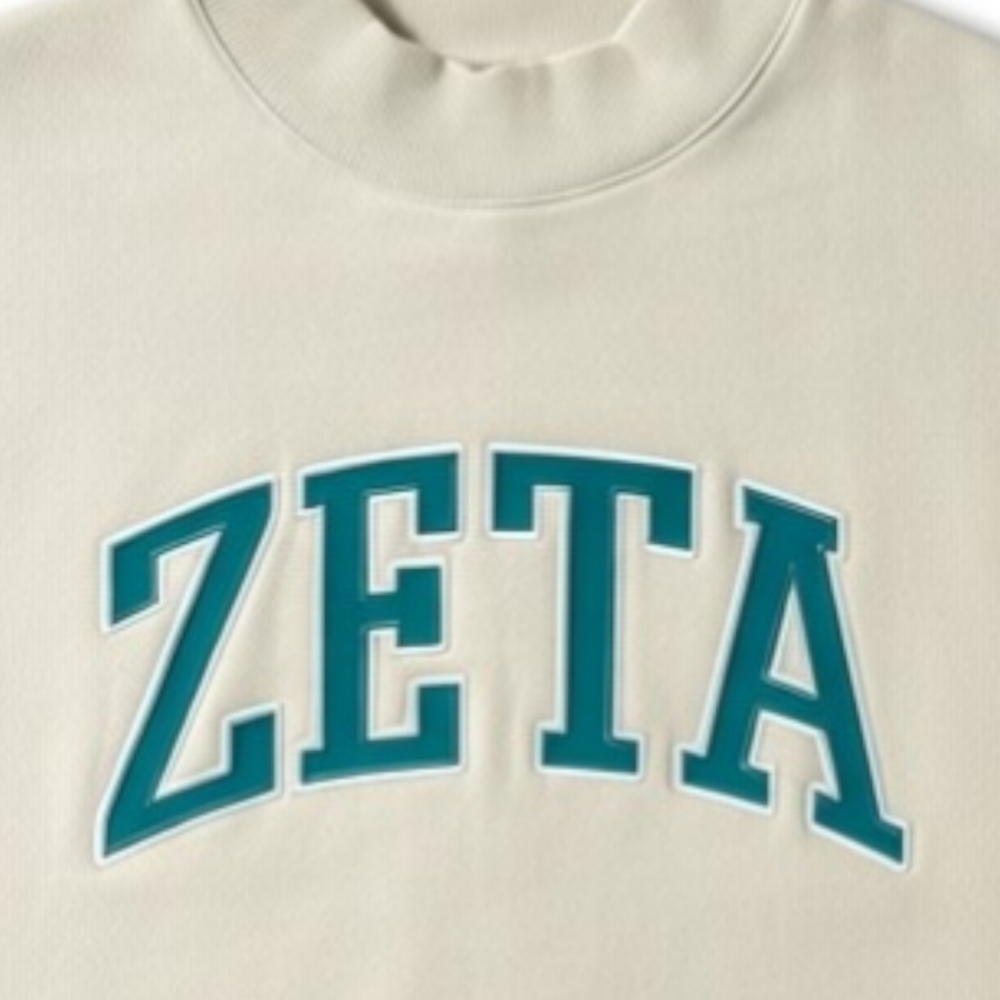 Beige sweatshirt with 'ZETA' printed in teal letters