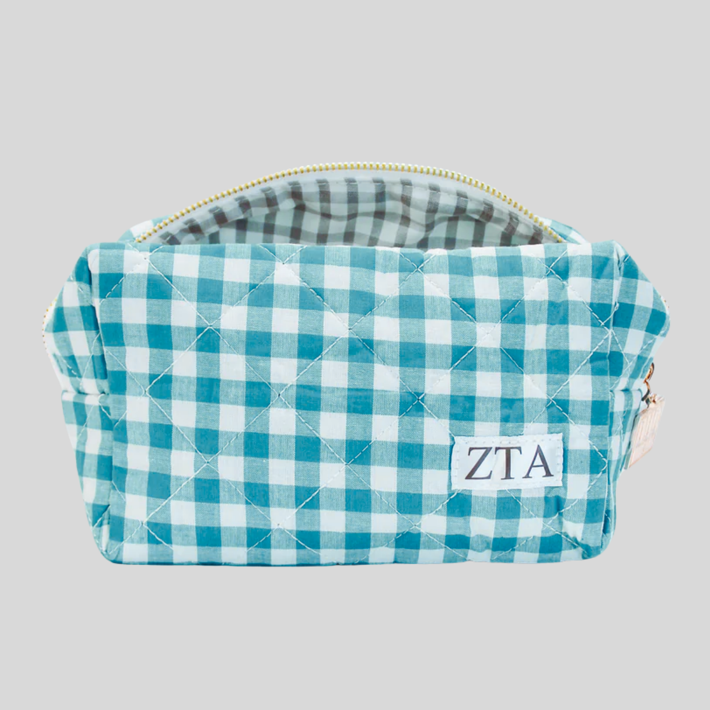 Teal and white checkered pouch with 'ZTA' monogram on a gray background