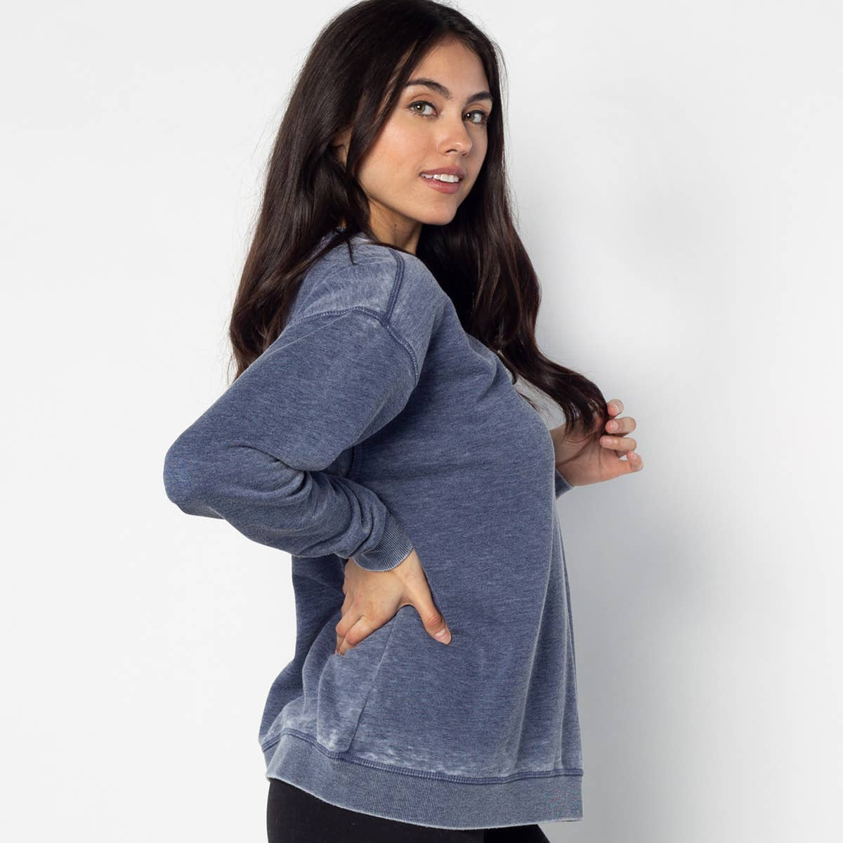 Woman wearing a blue pullover against a white background