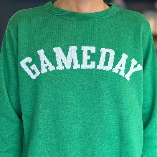 Green sweatshirt with 'GAMEDAY' text in white on a blurred background