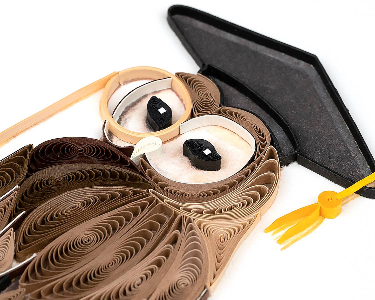 Quilled owl design on a white background with a graduation cap and tassel.