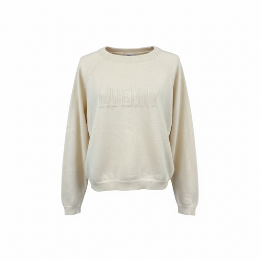 Beige sweater with LIBERTY embossed on a white background