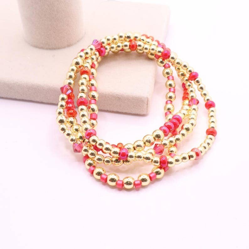 Town Pride State College hot pink and gold hematite stretch bracelet stack of five beaded bangles.