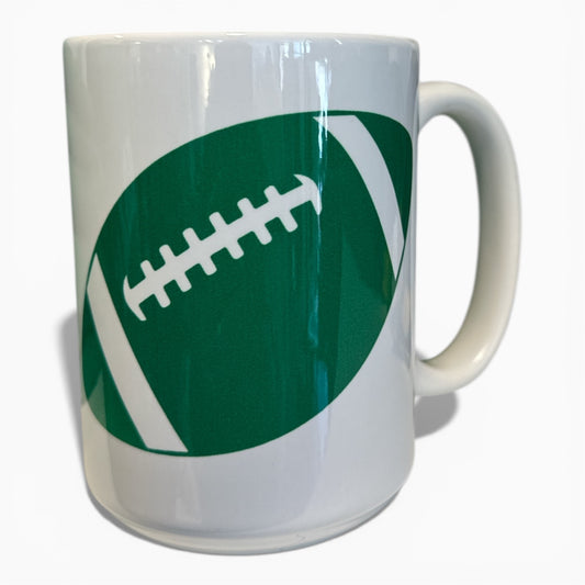 White mug with green football design on a white background